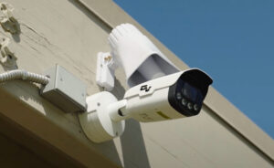 OnView security camera and audio deterrent speaker mounted on the exterior of a commercial building.