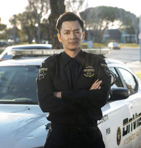 OnView security officer standing in front of a branded patrol vehicle.