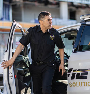 OnView security officer exiting a branded patrol vehicle while providing on-site security services.